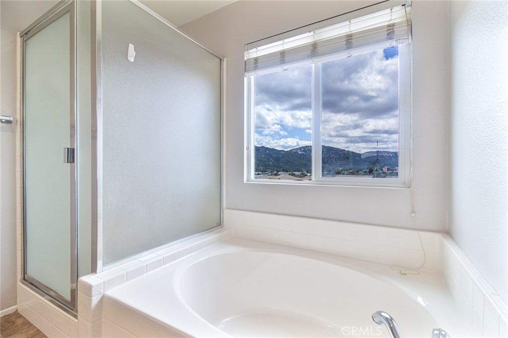 46321 Sharon Street Temecula, CA 92592 - Photo 35 of 40 a white bath tub sitting in a bathroom next to a window