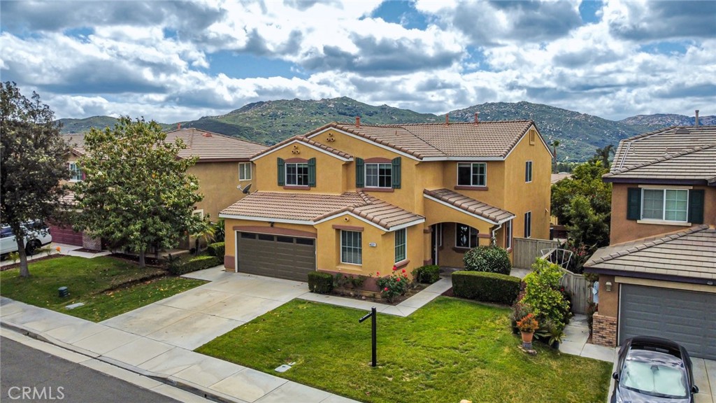 46321 Sharon Street Temecula, CA 92592 - Photo 6 of 40 a front view of a house with a yard