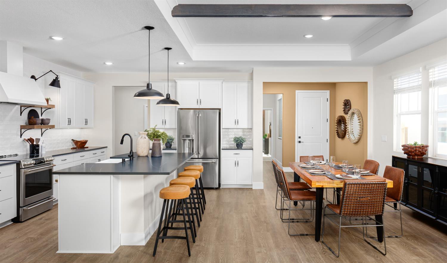 4452 Doric Way Rancho Cordova, CA 95742 - Photo 7 of 15 a dining room with stainless steel appliances kitchen island granite countertop a dining table chairs and a refrigerator
