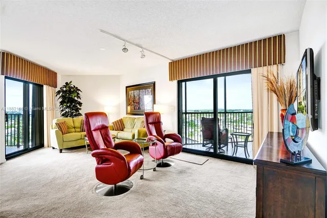 a living room with furniture fireplace and a large window