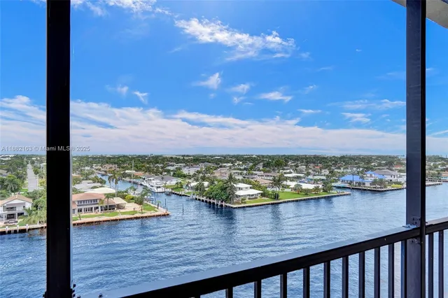 a living room with furniture a flat screen tv and a large window
