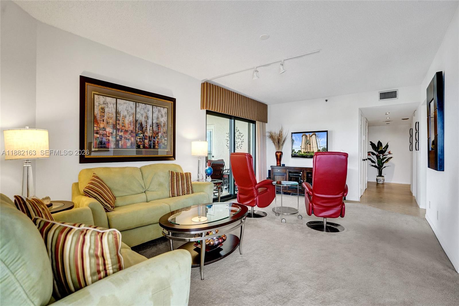 501 North Riverside Drive, Unit PH2 Pompano Beach, FL 33062 - Photo 28 of 83 a living room with furniture a rug and a painting on the wall