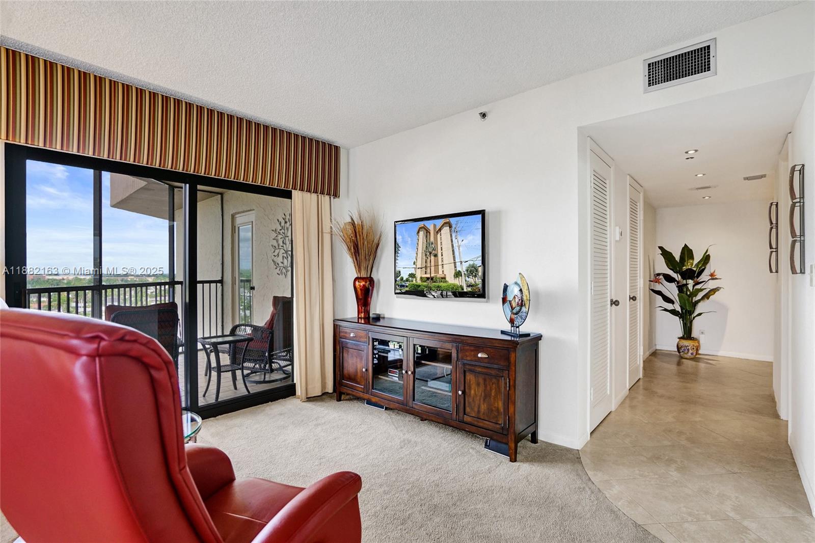 501 North Riverside Drive, Unit PH2 Pompano Beach, FL 33062 - Photo 30 of 80 a living room with furniture a flat screen tv and a large window