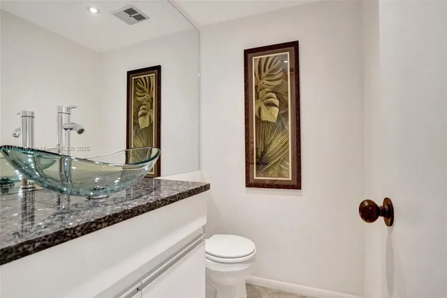 a bedroom with a bed and a lamp on dresser