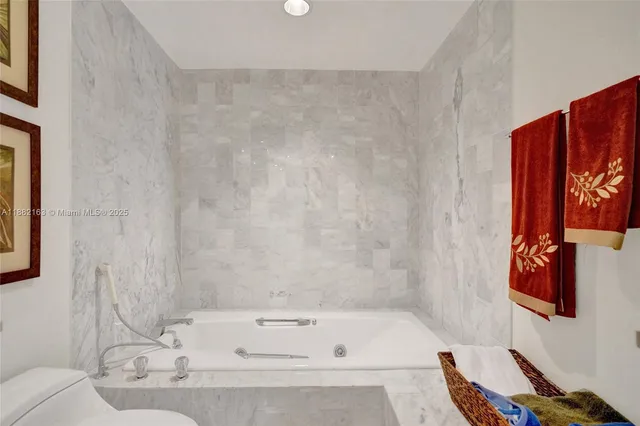 a bathroom with a granite countertop sink and a large mirror
