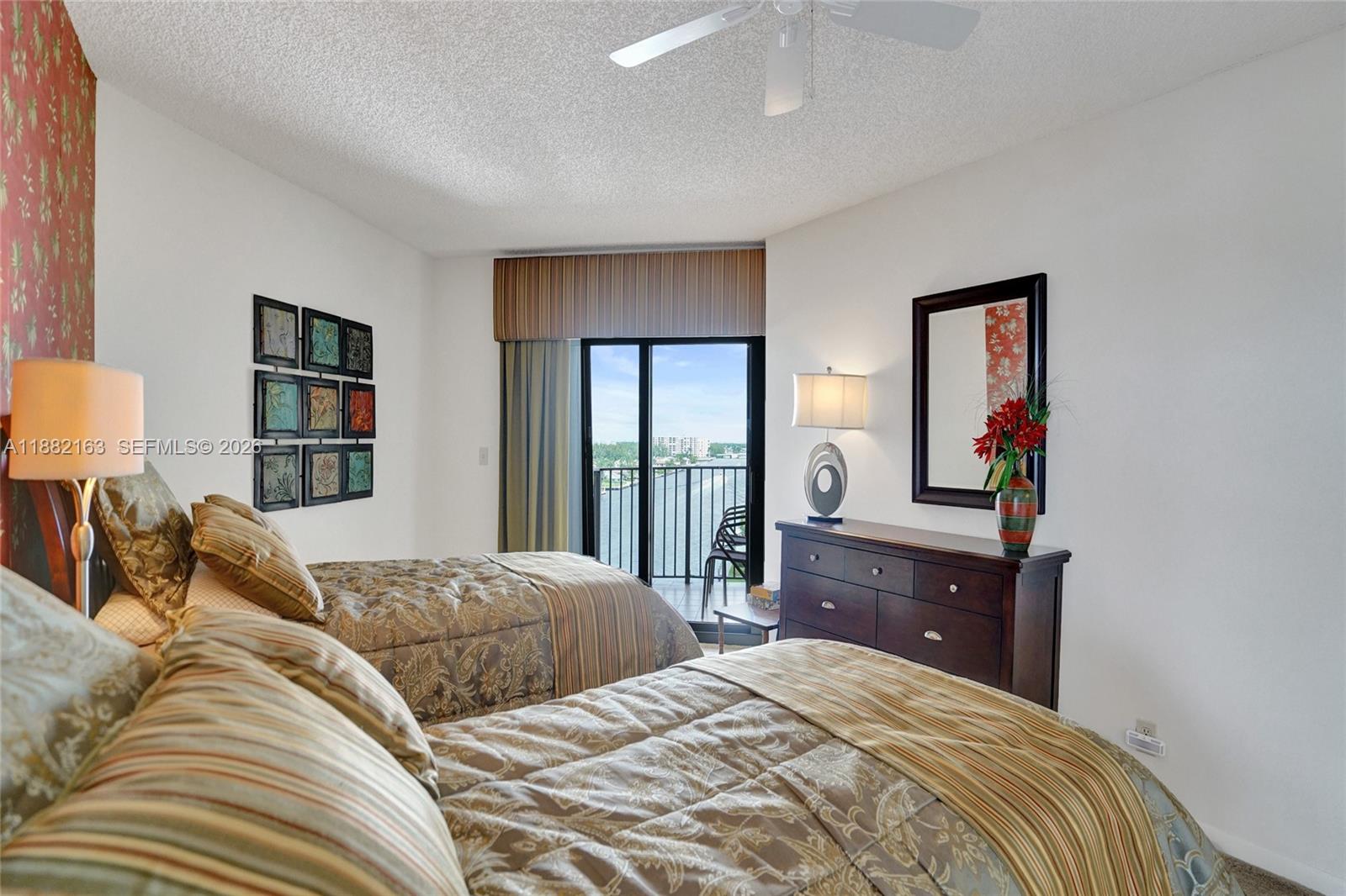 501 North Riverside Drive, Unit PH2 Pompano Beach, FL 33062 - Photo 43 of 83 a bedroom with a bed and a lamp on dresser