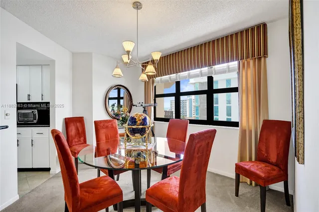 a dining room with furniture a chandelier and window