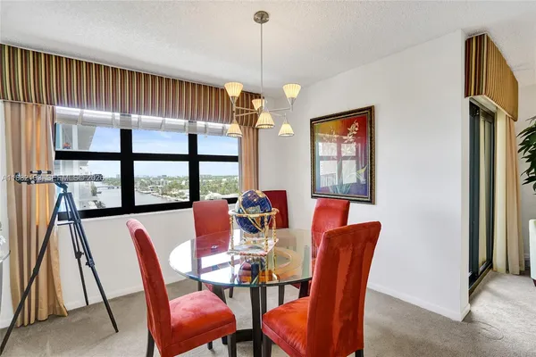 a view of a dining room with furniture and a chandelier