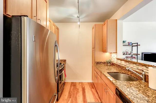 a kitchen with a refrigerator and a sink