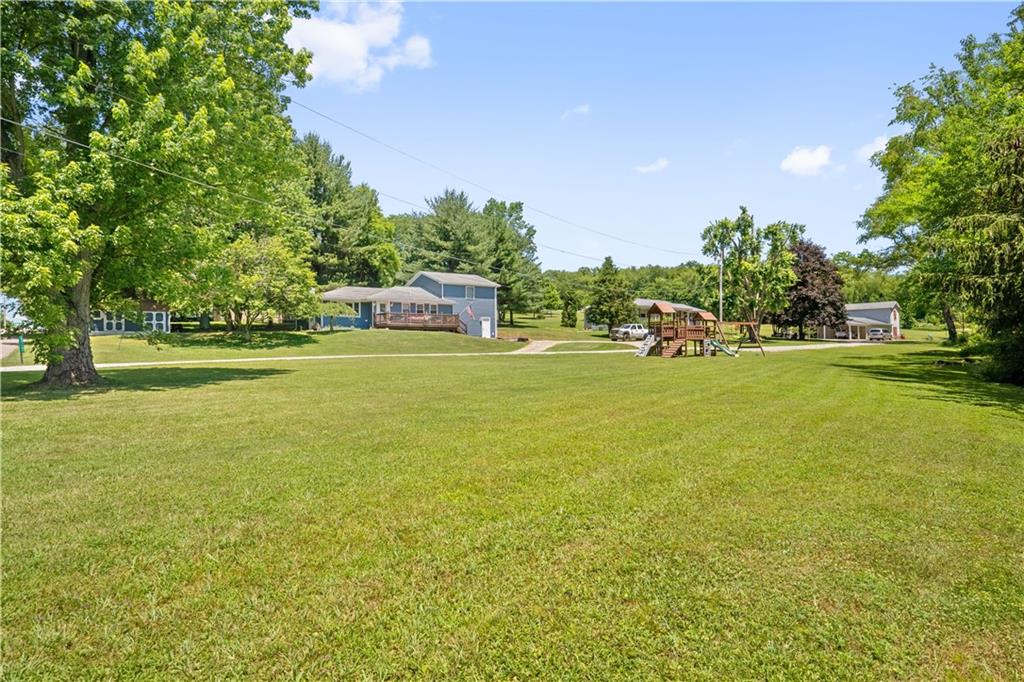 103 Stone Road Dawson, PA 15428 - Photo 2 of 25 a view of a water with lawn chairs under an umbrella