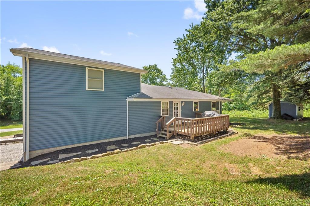 103 Stone Road Dawson, PA 15428 - Photo 23 of 25 a front view of house with yard and trees in the background