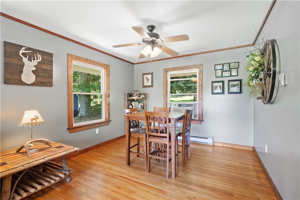 103 Stone Road Dawson, PA 15428 - Photo 8 of 25 a view of a dining room with furniture window and wooden floor