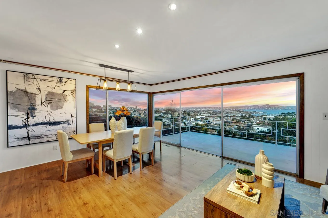 1141 Akron Street San Diego, CA 92106 - Photo 17 of 44 a dining room with furniture a chandelier and wooden floor