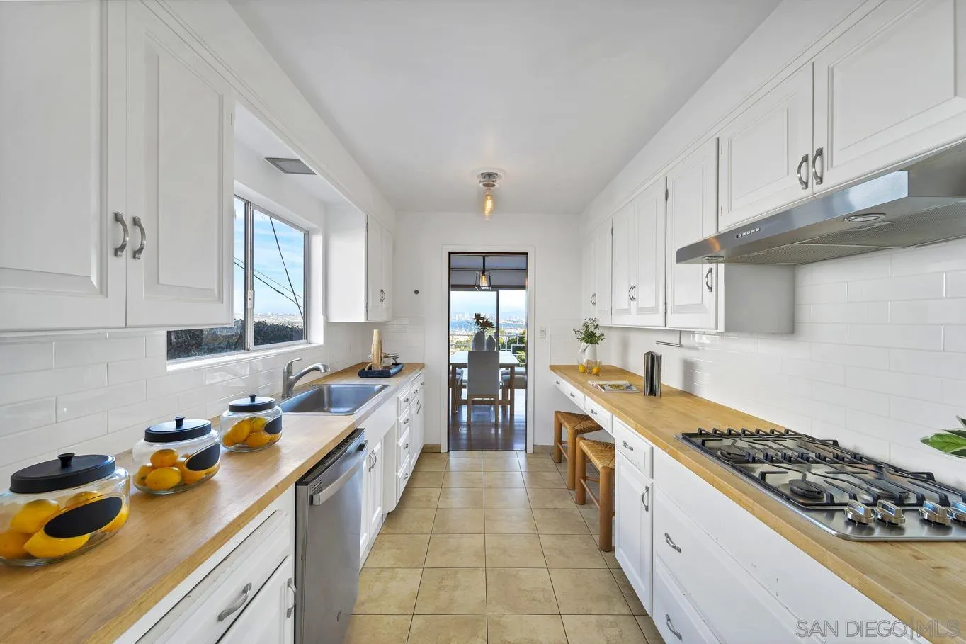 1141 Akron Street San Diego, CA 92106 - Photo 24 of 44 a large kitchen with stainless steel appliances granite countertop a lot of counter space and wooden floors