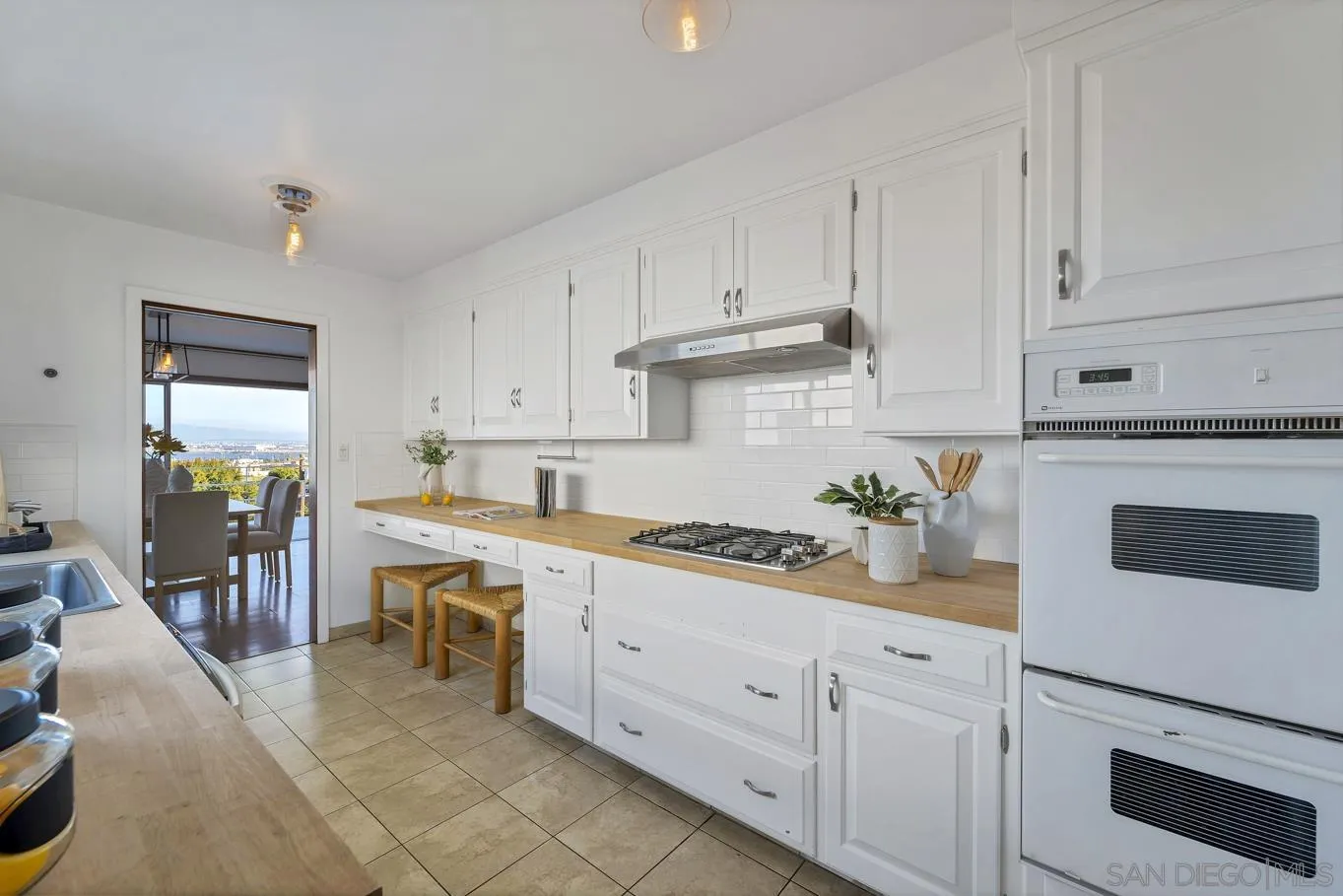 1141 Akron Street San Diego, CA 92106 - Photo 25 of 44 a kitchen with white cabinets and white appliances