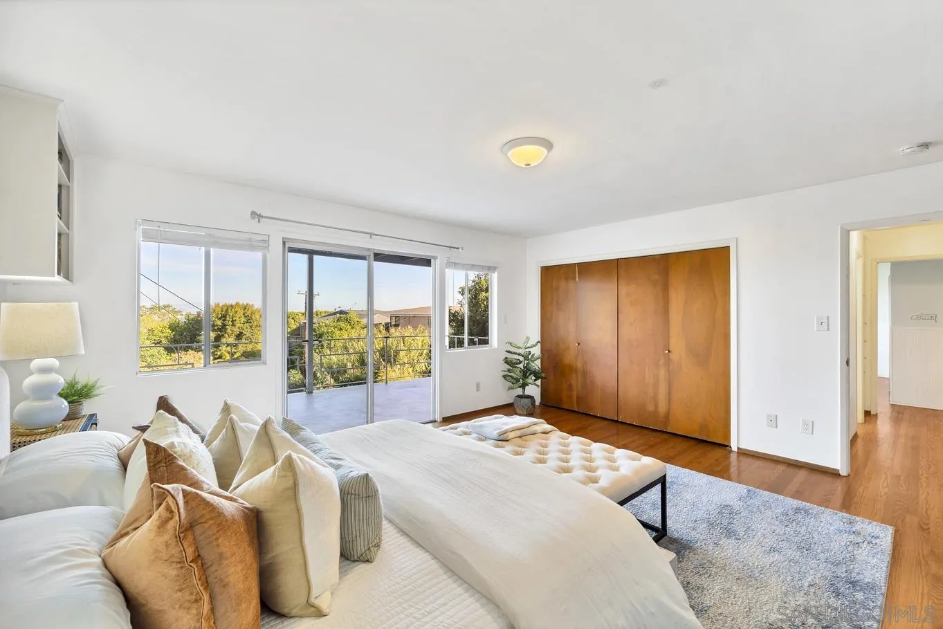 1141 Akron Street San Diego, CA 92106 - Photo 30 of 44 a spacious bedroom with a bed and glass windows