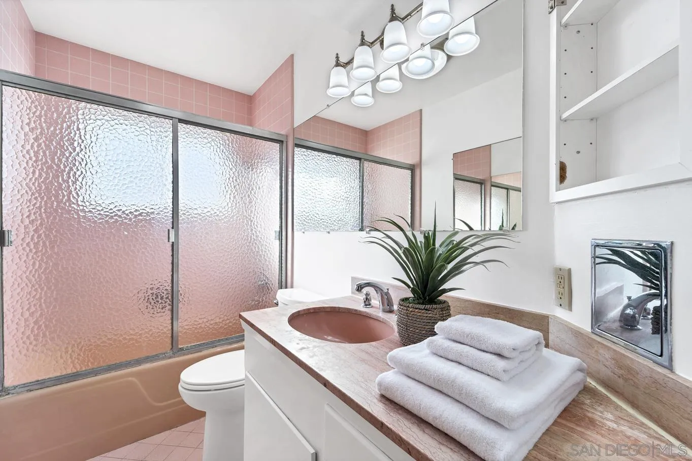 1141 Akron Street San Diego, CA 92106 - Photo 36 of 44 a bathroom with a granite countertop sink a toilet and a mirror