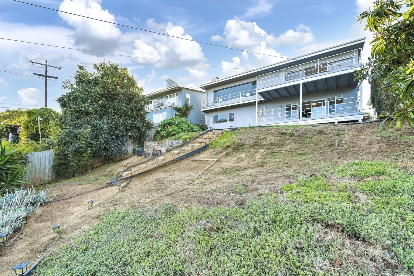 1141 Akron Street San Diego, CA 92106 - Photo 38 of 44 a house with trees in front of it