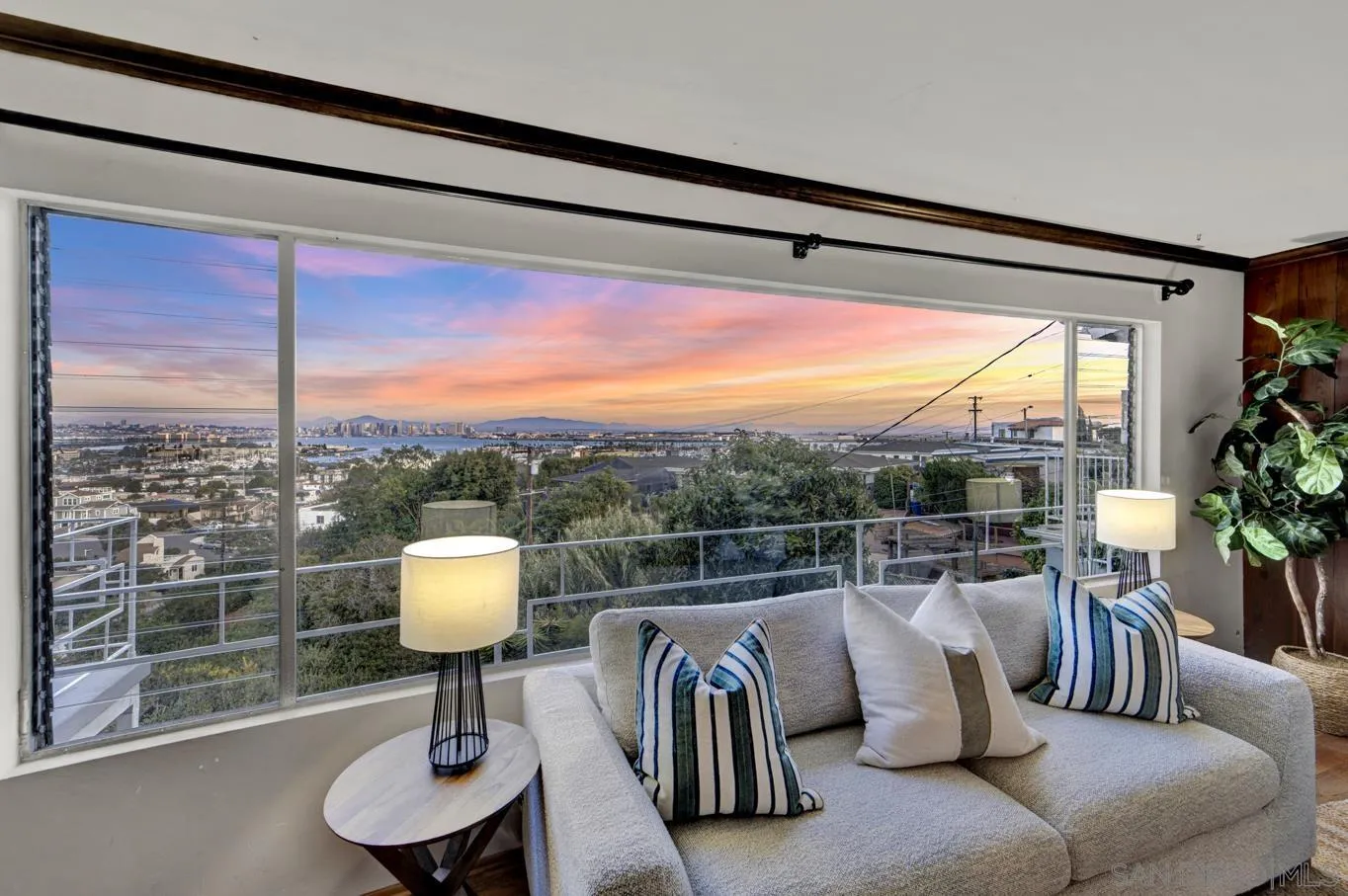 1141 Akron Street San Diego, CA 92106 - Photo 10 of 44 a view of a living room and a floor to ceiling window and a table