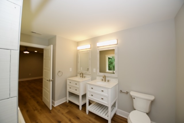 317 Pendleton Road Clemson, SC 29631 - Photo 27 of 36 Dual vanities and rich hardwood flooring create a spacious and elegant bathroom retreat.