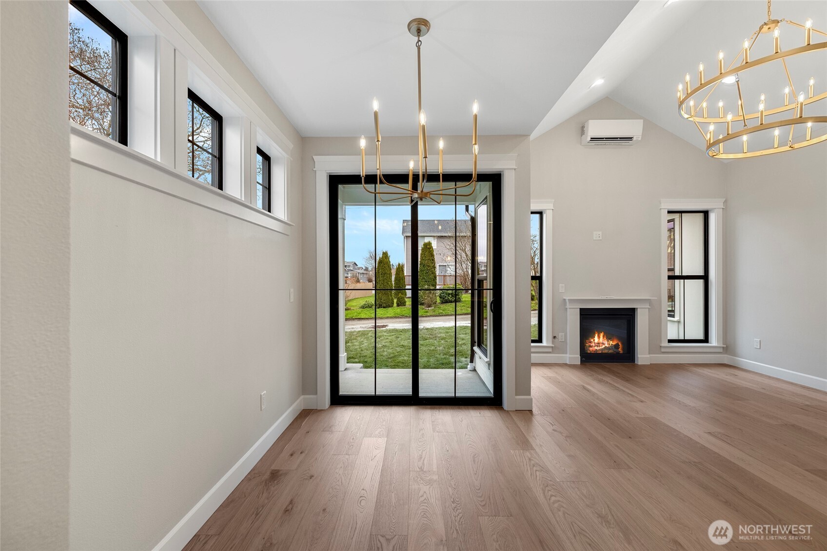 1211 King Street Anacortes, WA 98221 - Photo 12 of 40 a view of an empty room with wooden floor fireplace and a window