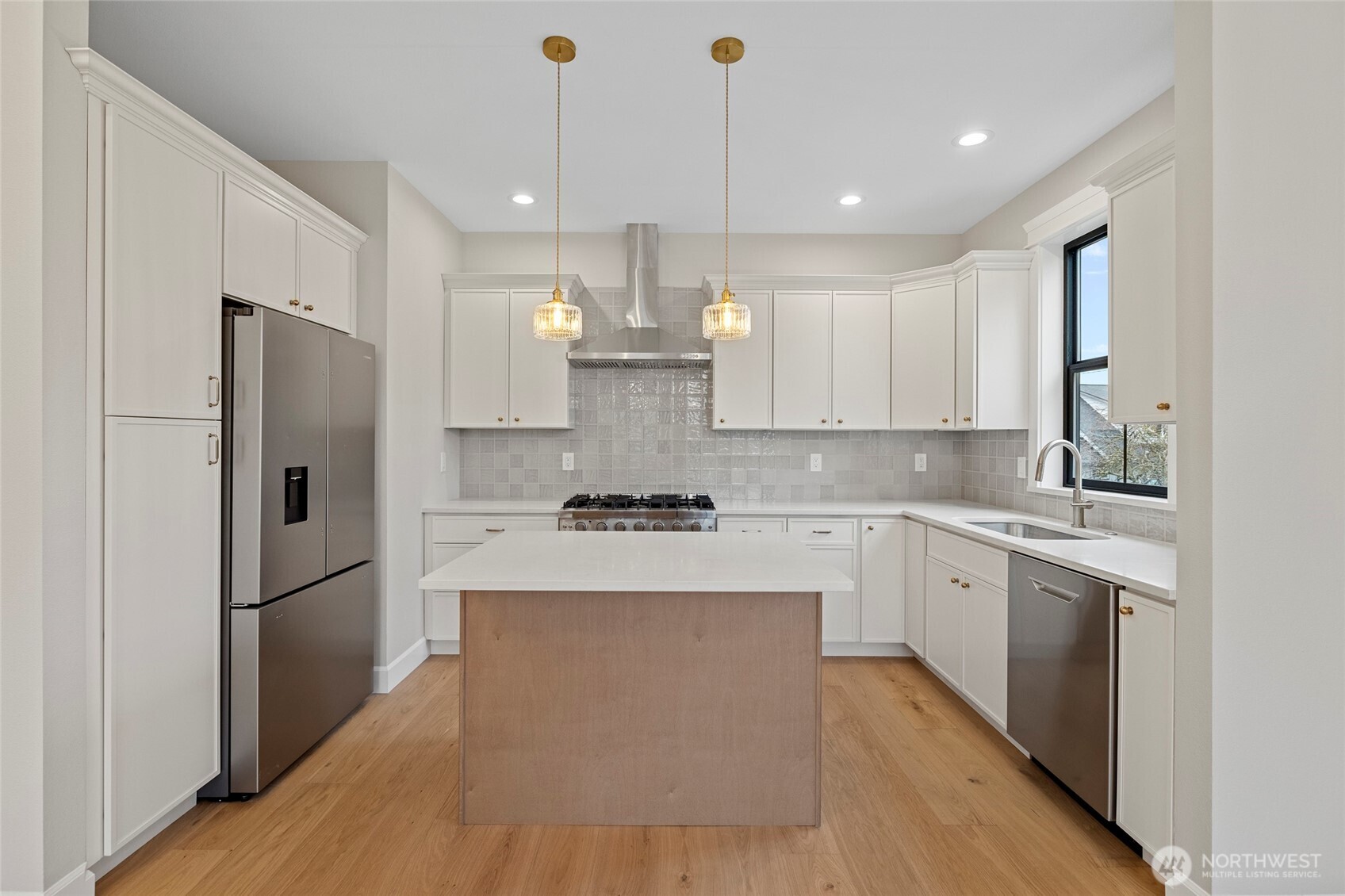 1211 King Street Anacortes, WA 98221 - Photo 13 of 40 a kitchen with kitchen island white cabinets and stainless steel appliances