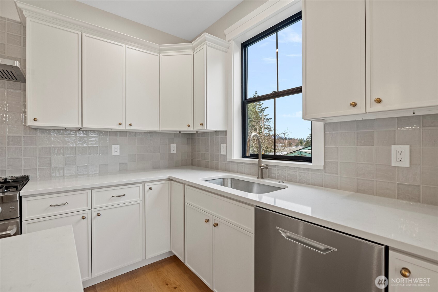 1211 King Street Anacortes, WA 98221 - Photo 15 of 40 a kitchen with white cabinets and a window