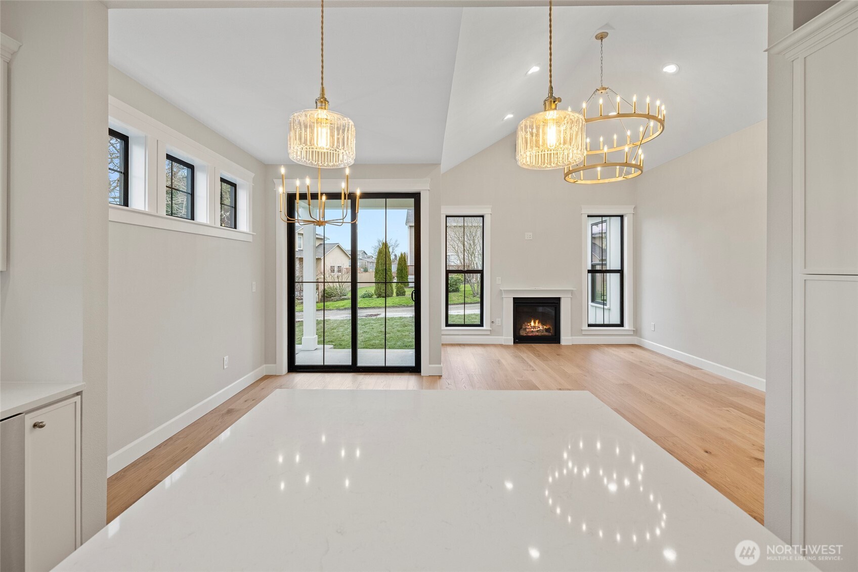 1211 King Street Anacortes, WA 98221 - Photo 19 of 40 a view of a room with a chandelier and fireplace