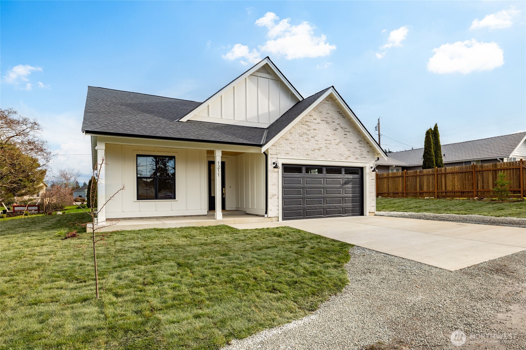 1211 King Street Anacortes, WA 98221 - Photo 2 of 40 a front view of a house with a yard and garage
