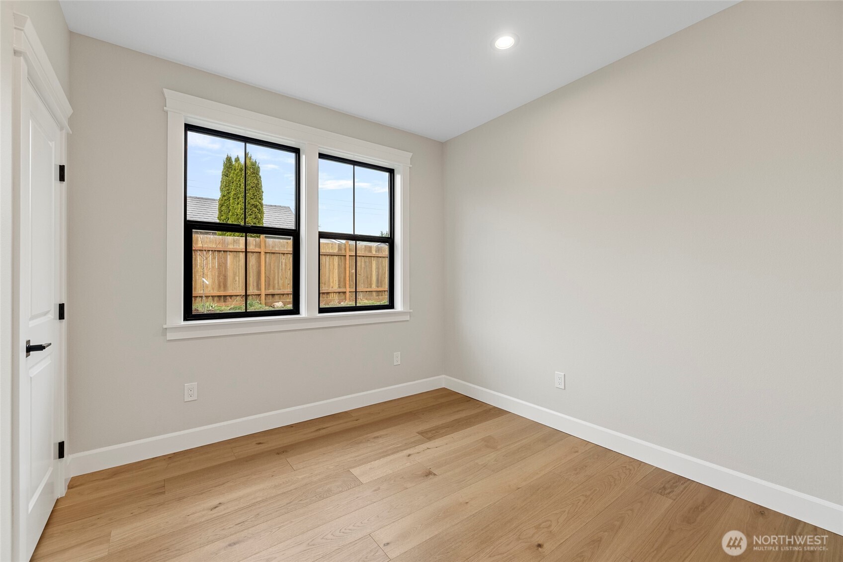 1211 King Street Anacortes, WA 98221 - Photo 28 of 40 an empty room with wooden floor and windows