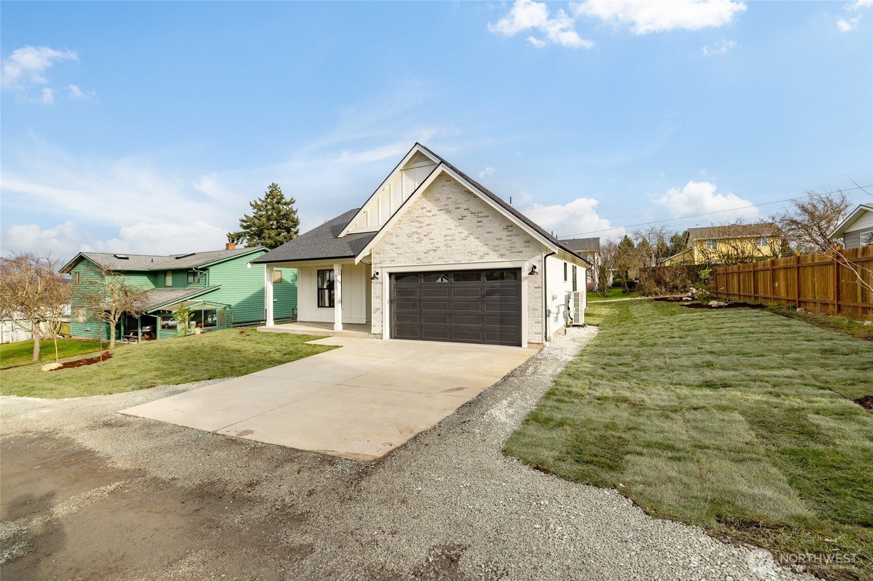 1211 King Street Anacortes, WA 98221 - Photo 3 of 40 a front view of house with yard and trees in the background