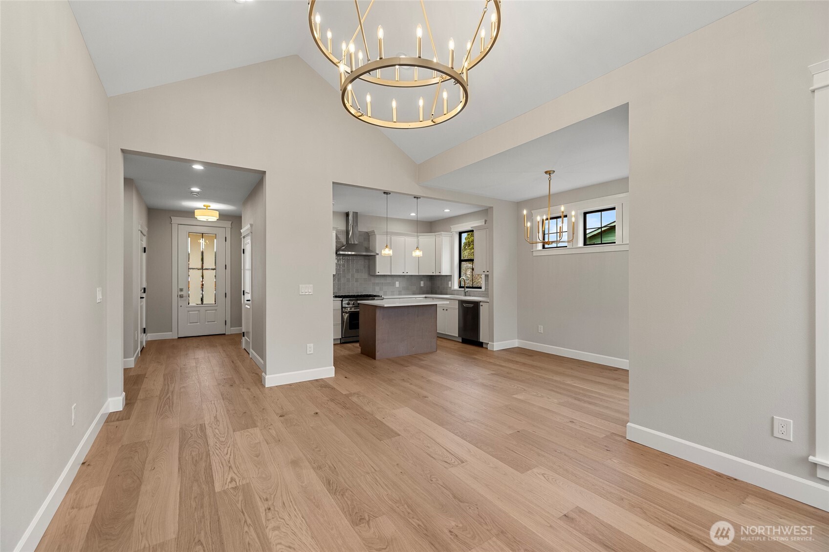 1211 King Street Anacortes, WA 98221 - Photo 7 of 40 a view of a kitchen with a sink and dishwasher a refrigerator with wooden floor