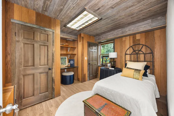a bedroom with a large bed and a chandelier