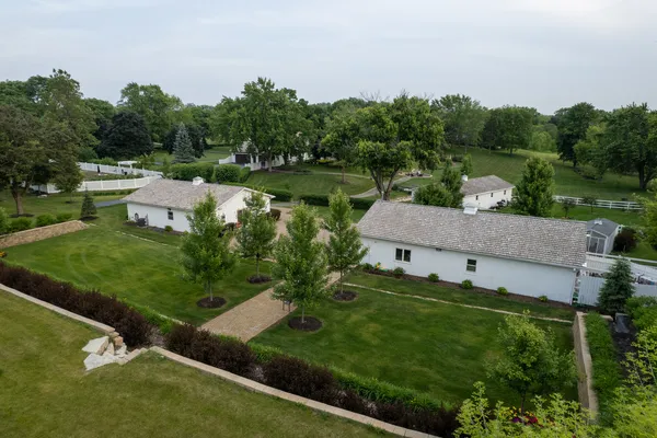 an aerial view of a house with a garden and trees
