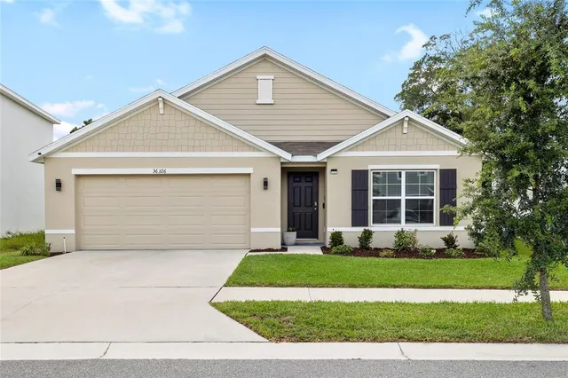 a front view of a house with a yard and garage