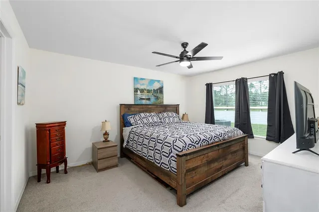 a bed sitting in a bedroom next to a window