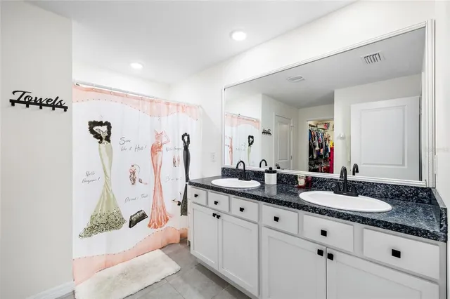 a bathroom with double sink and a mirror