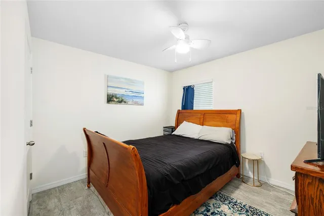 a bedroom with a bed and lamp