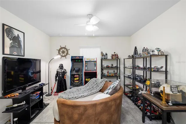 a living room with furniture a flat screen tv and a window