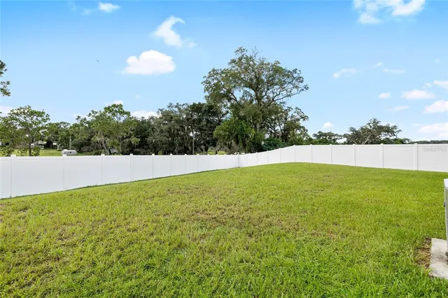 a view of yard with swimming pool and seating area