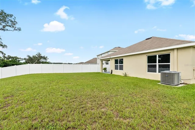 a view of an house with backyard space and balcony