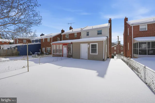 a view of a house with a snow in the background