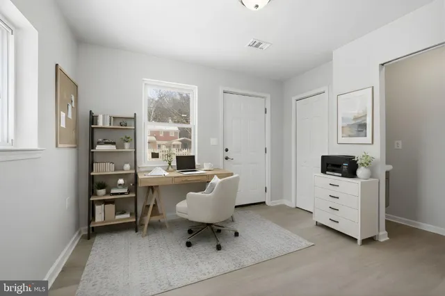 a living room with furniture a window and a flat screen tv
