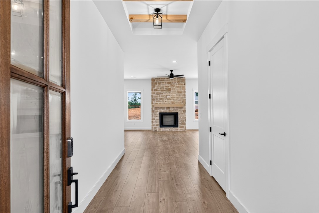 416 Blume Road Anderson, SC 29625 - Photo 5 of 29 A welcoming entry hall with hardwood flooring leads to a cozy living space featuring a prominent stone fireplace.