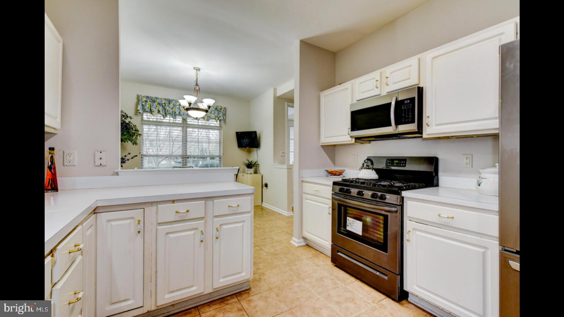 25 Cardinal Flower Lane Princeton Junction, NJ 08550 - Photo 21 of 54 a kitchen with granite countertop white cabinets stainless steel appliances and a counter space