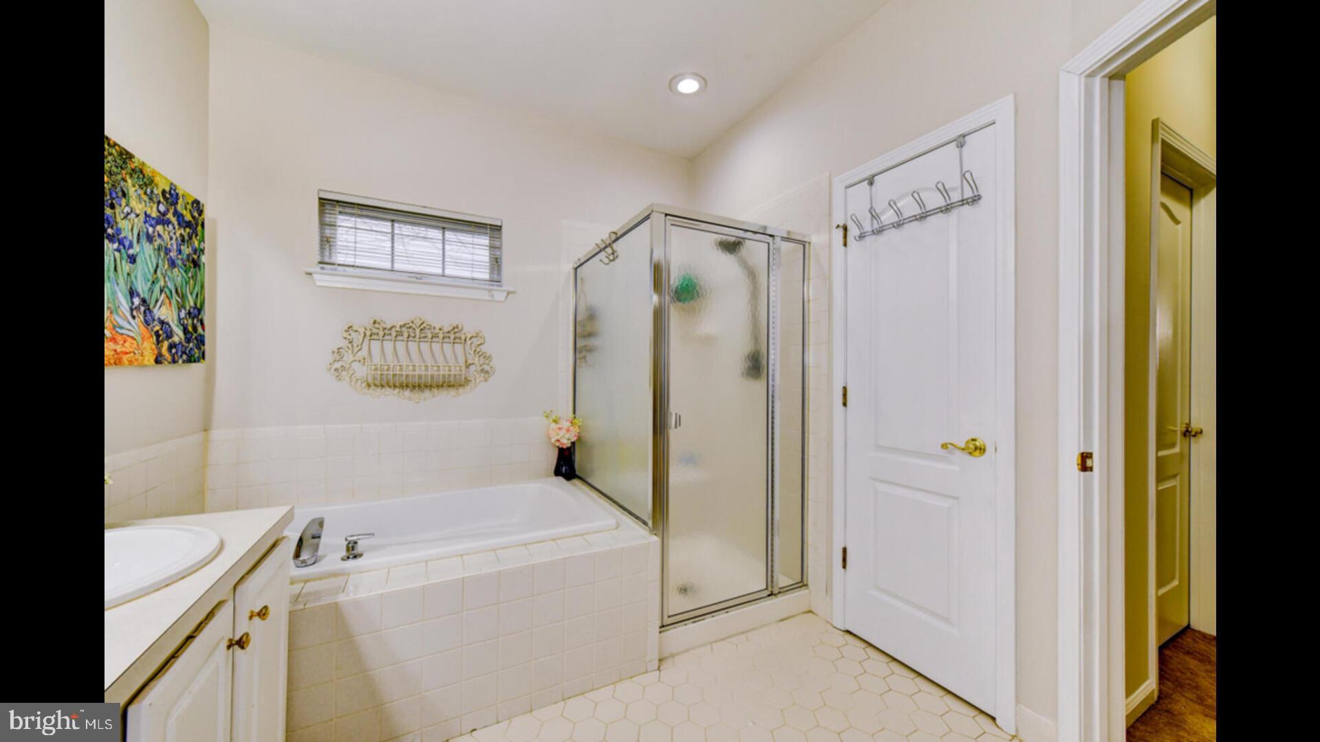 25 Cardinal Flower Lane Princeton Junction, NJ 08550 - Photo 26 of 54 a bathroom with a tub a sink and a shower
