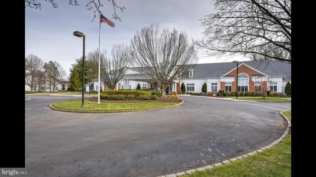 a living room with fireplace furniture and a large window