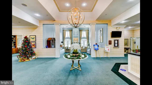 a living room with fireplace furniture and a chandelier