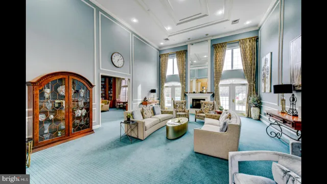 a living room with furniture and large windows