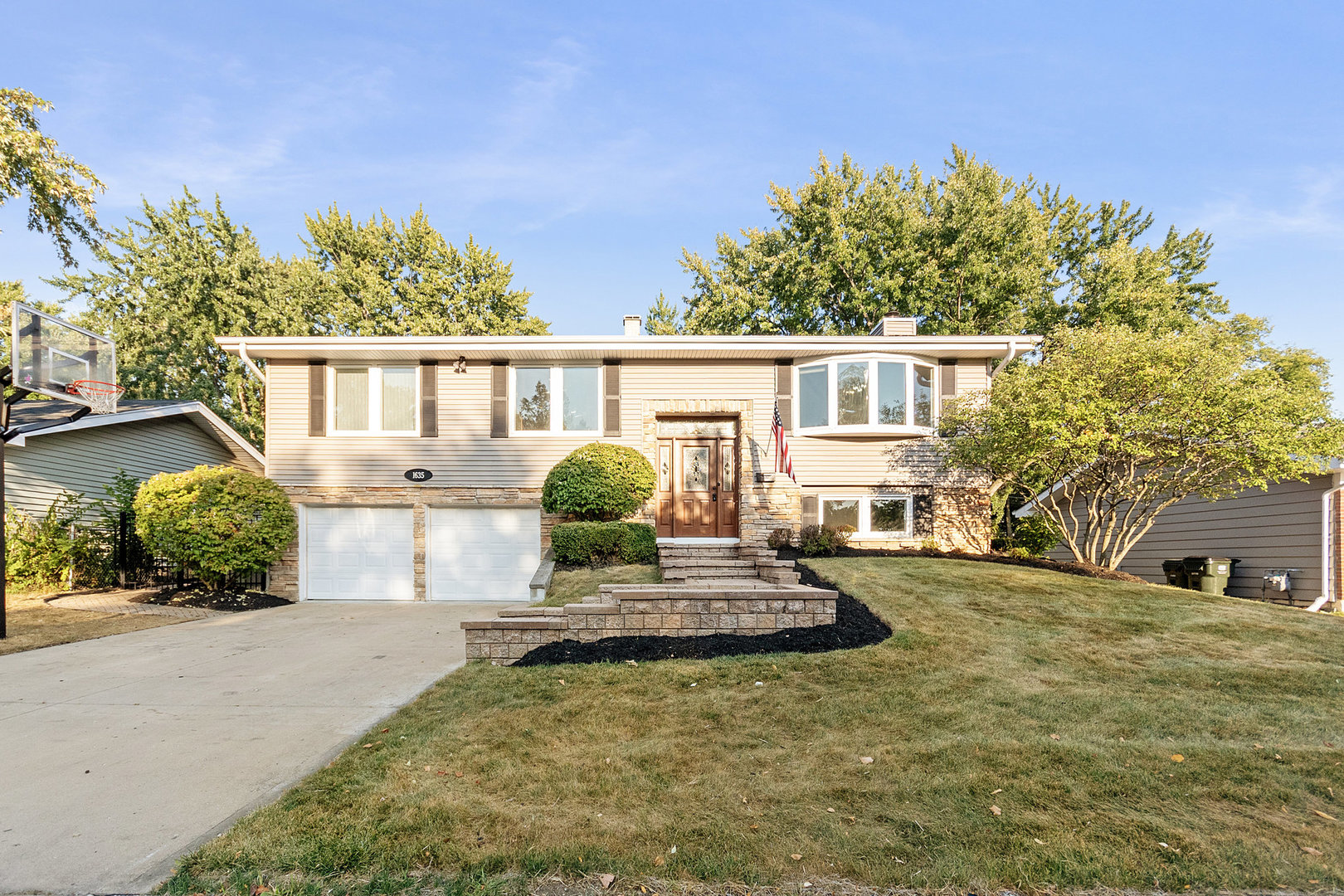 1635 Chippendale Road Hoffman Estates, IL 60169 - Photo 1 of 27 a front view of a house with garden